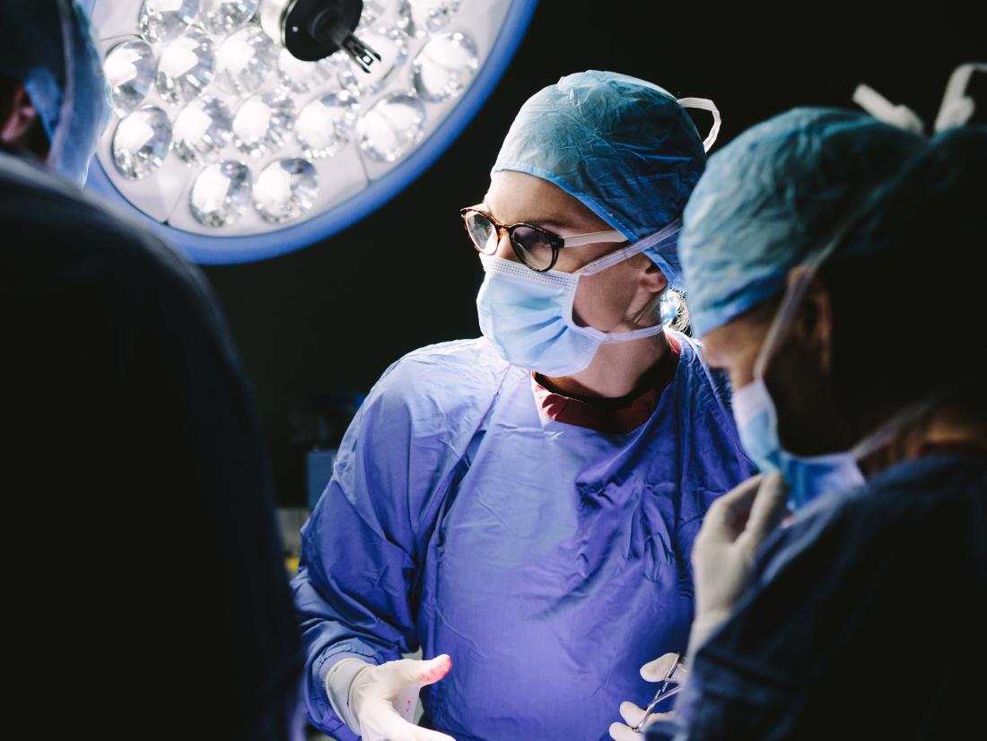 A group of surgeons performing surgery for a herniated disc